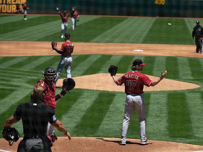 Arizona Diamondbacks starting pitcher Matt Peacock (47) reacts to a safe call by umpires after center fielder Ketel Marte appeared to catch a deep fly ball by Oakland Athletics center fielder Mark Canha.